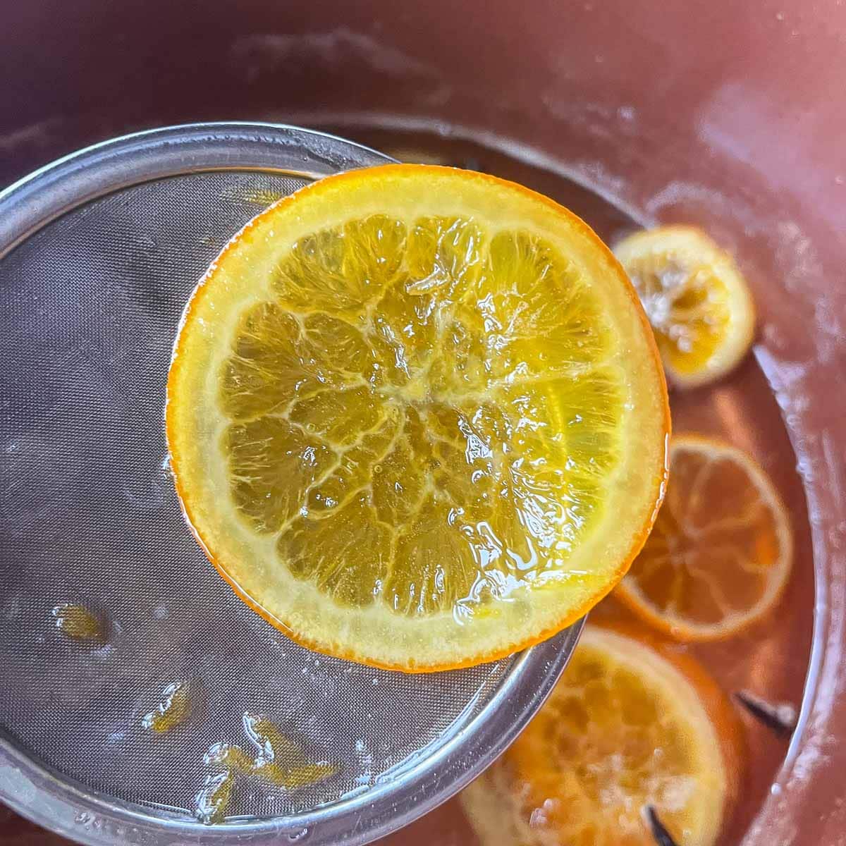 removing orange slices from orange syrup
