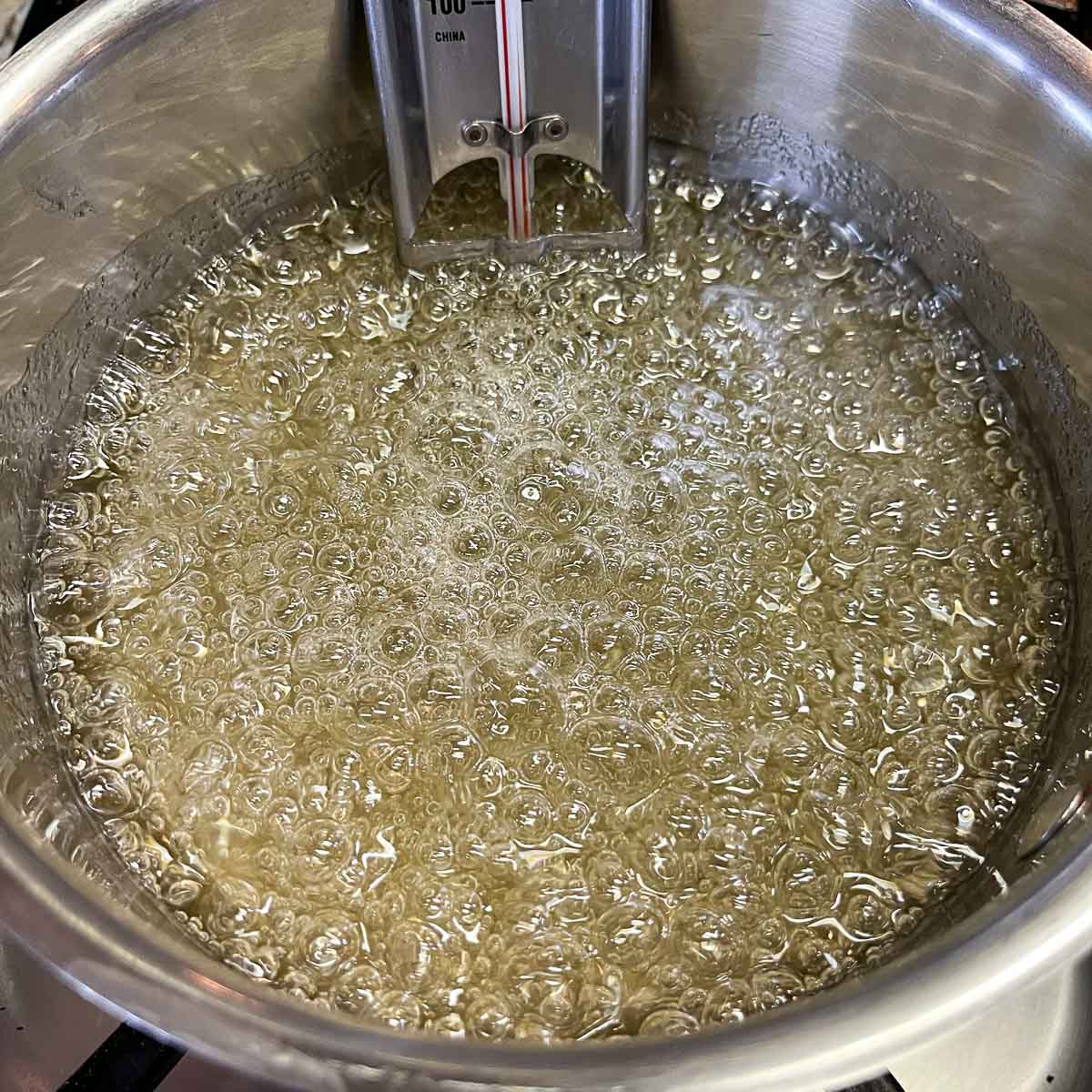 boiling syrup in a pot with candy thermometer