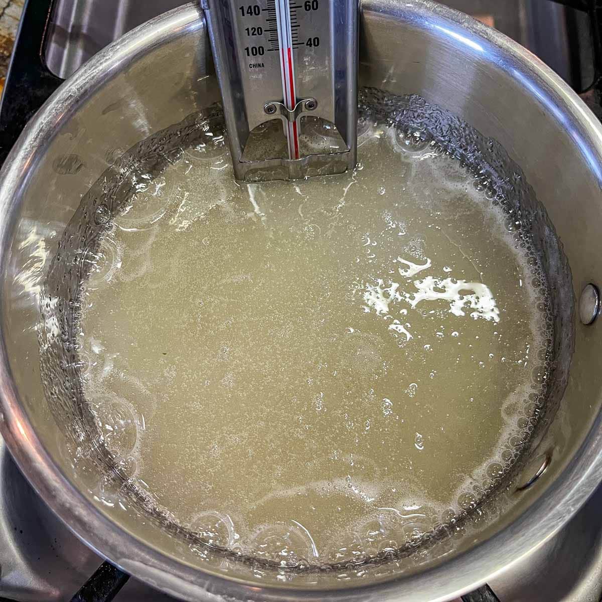 syrup in a pot with candy thermometer
