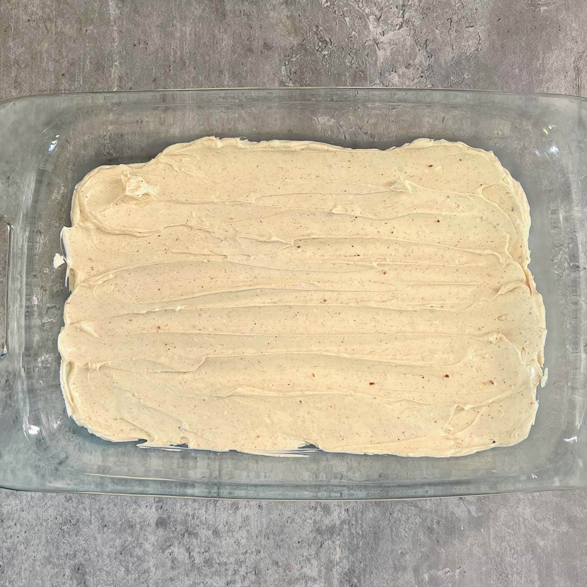 cream cheese layer of Mexican bean dip in pan