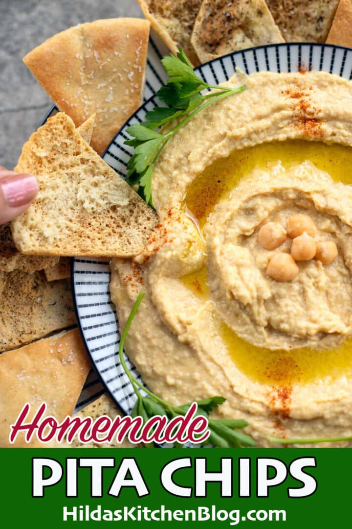 pita chips being dipped into hummus