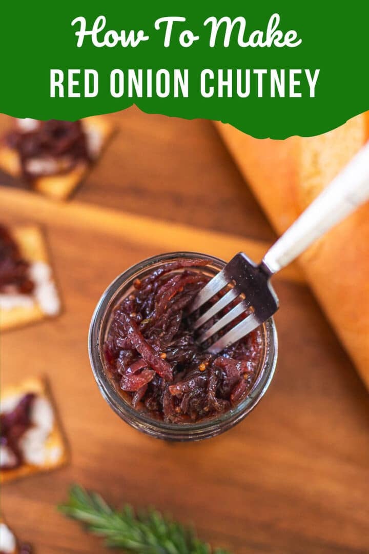red onion chutney in mason jar with fork beside rosemary, bread, crackers