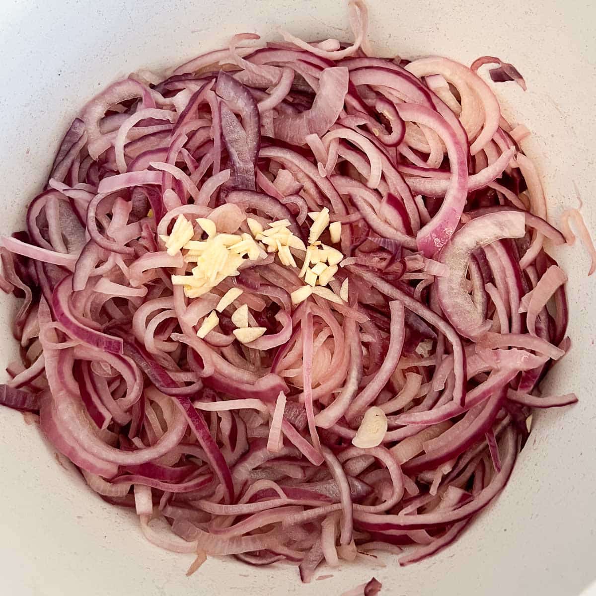 softened onions with chopped garlic in pot