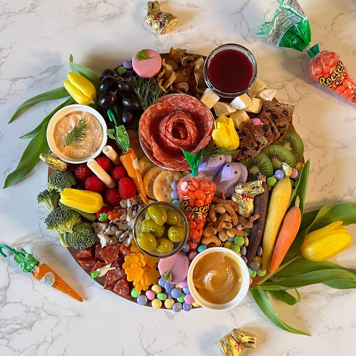 complete easter charcuterie board surrounded by loose candies