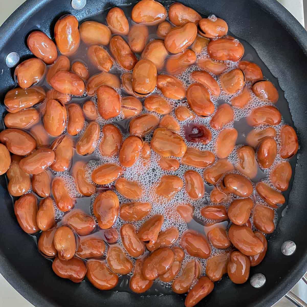 fava beans cooking in a pan