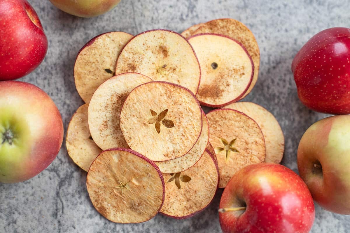 freeze dried apple slices with apples around them