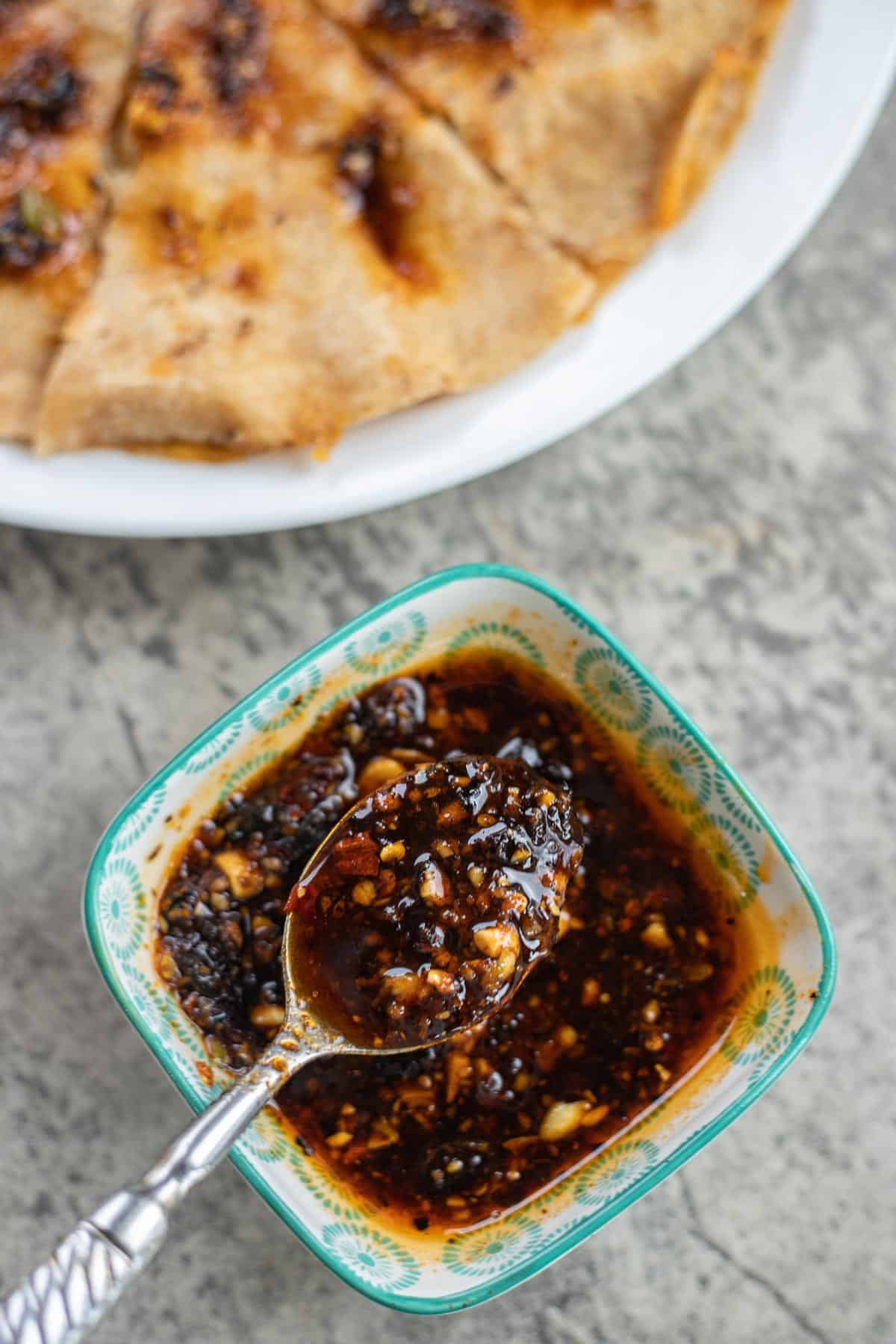 a bowl of macha salsa with a quesadilla next to it