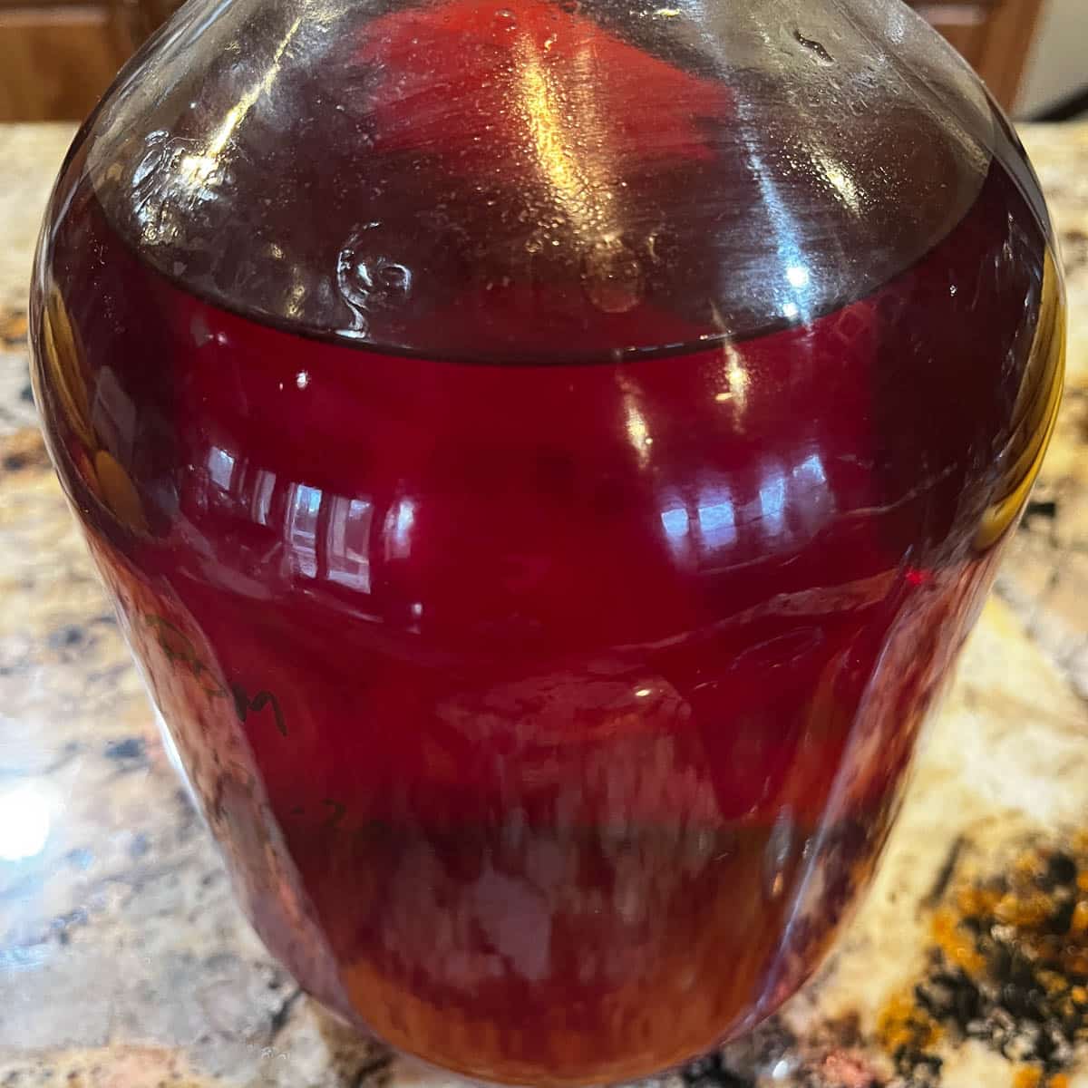pomegranate wine in a carboy