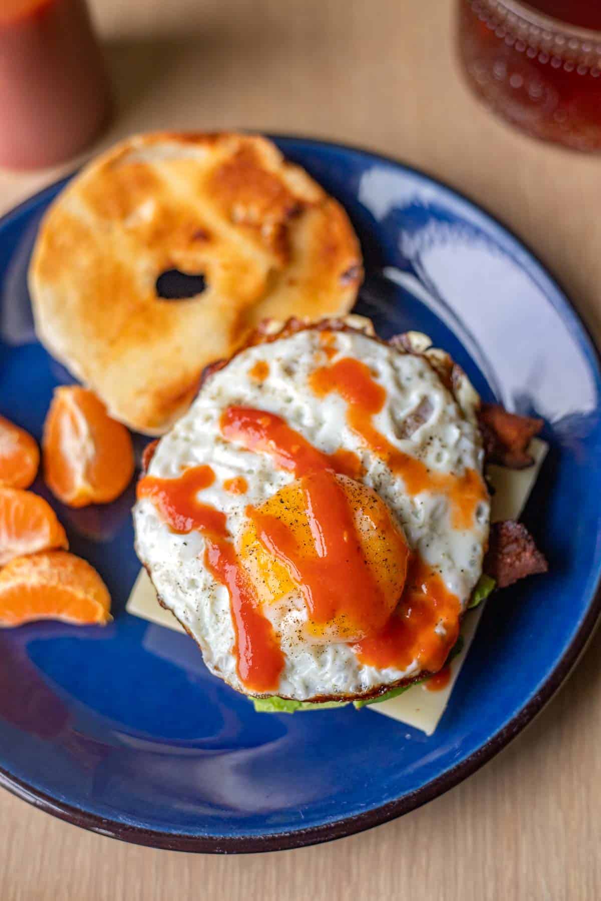 a bagel breakfast sandwich on a blue plate