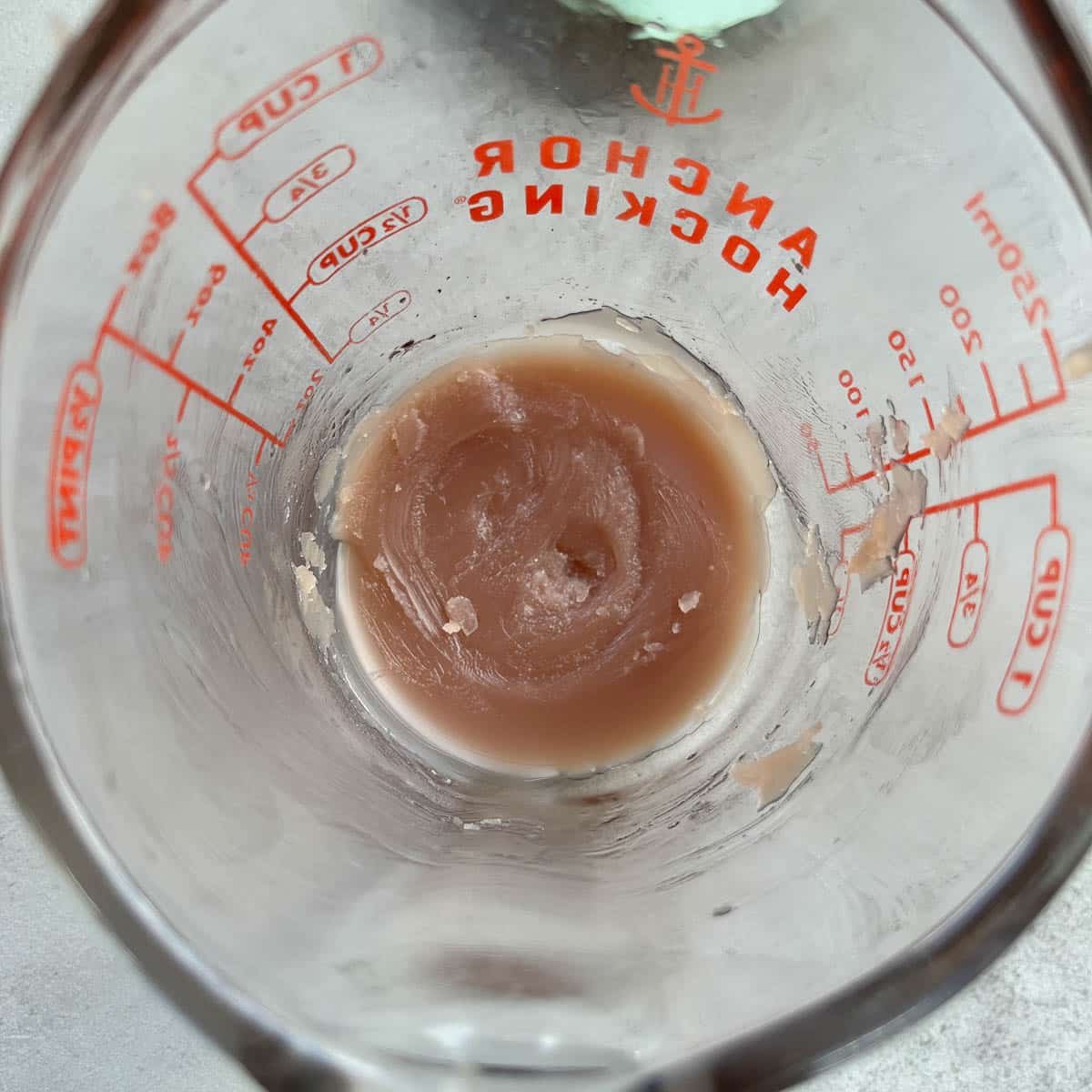 a small amount of balm of gilead in a measuring cup.