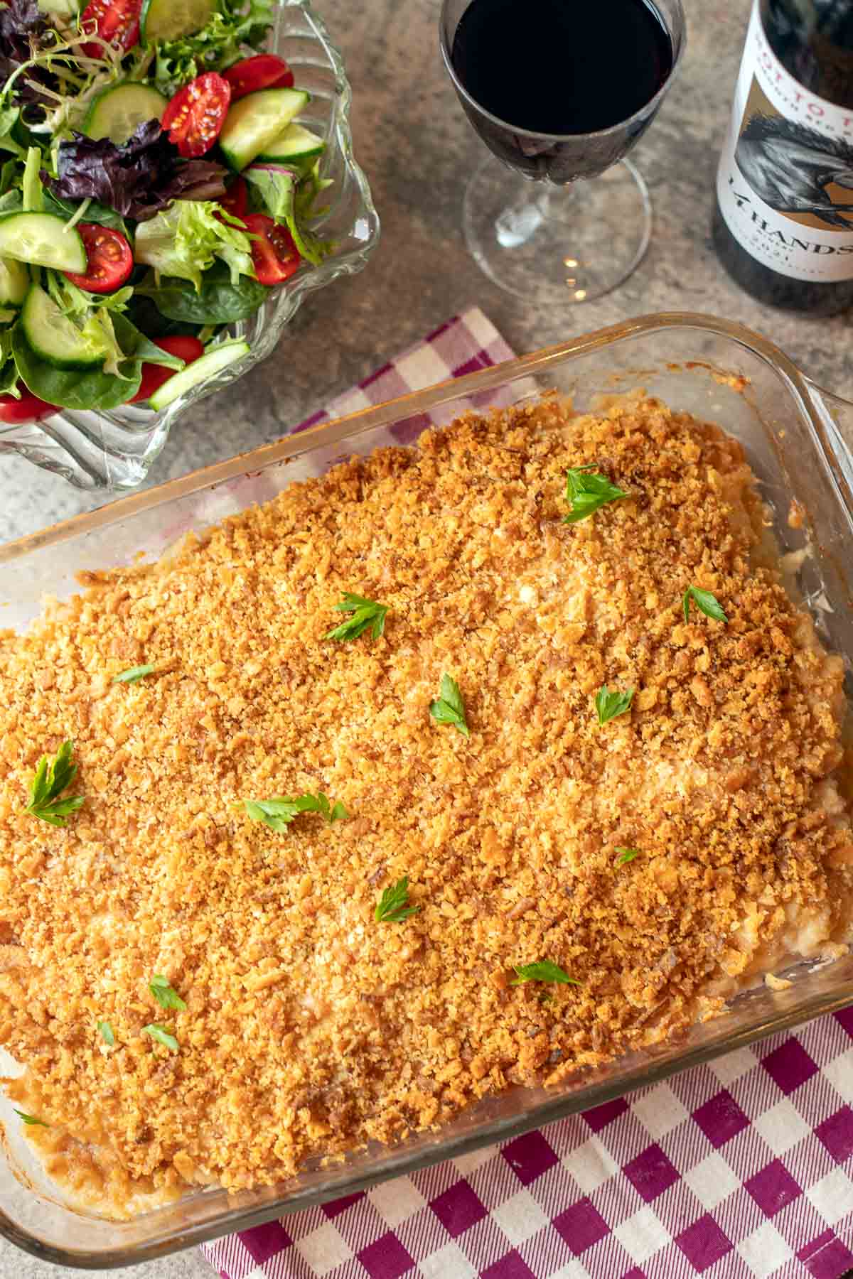 chicken cordon bleu casserole with salad and wine