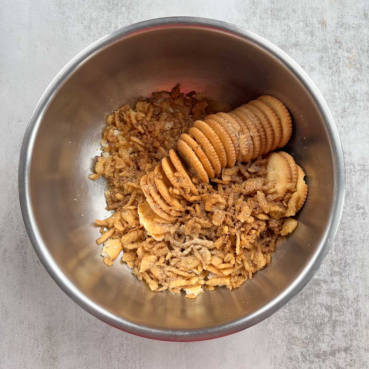 silver bowl with crackers and fried onions.