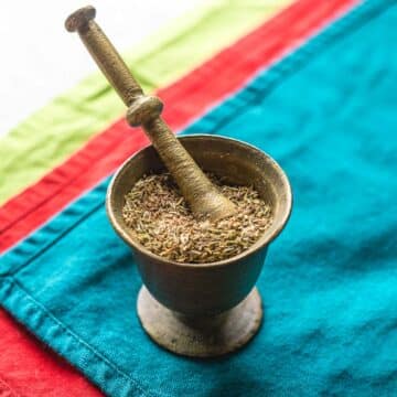 seasoning in mortar on colorful placemats