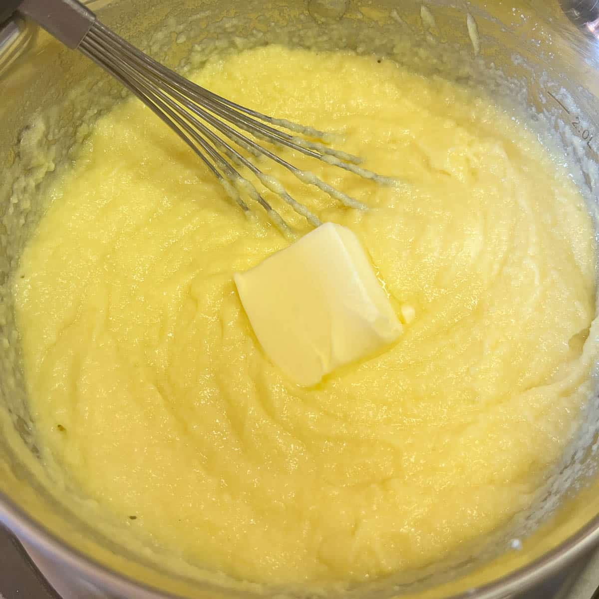 whisking butter into custard.