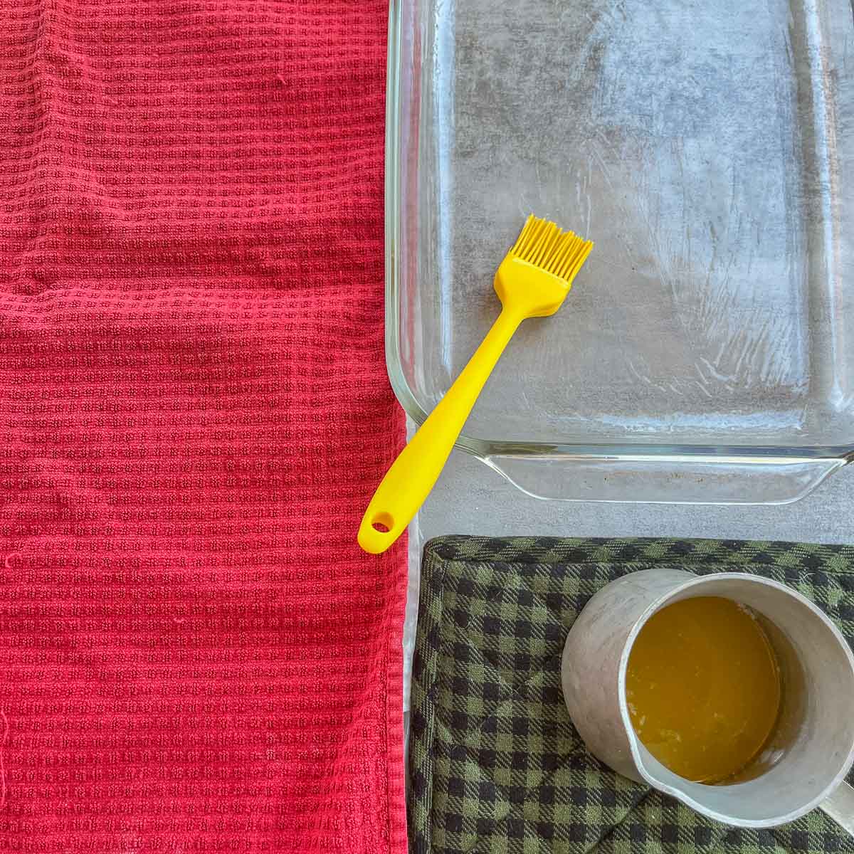 brushing baking dish with butter.