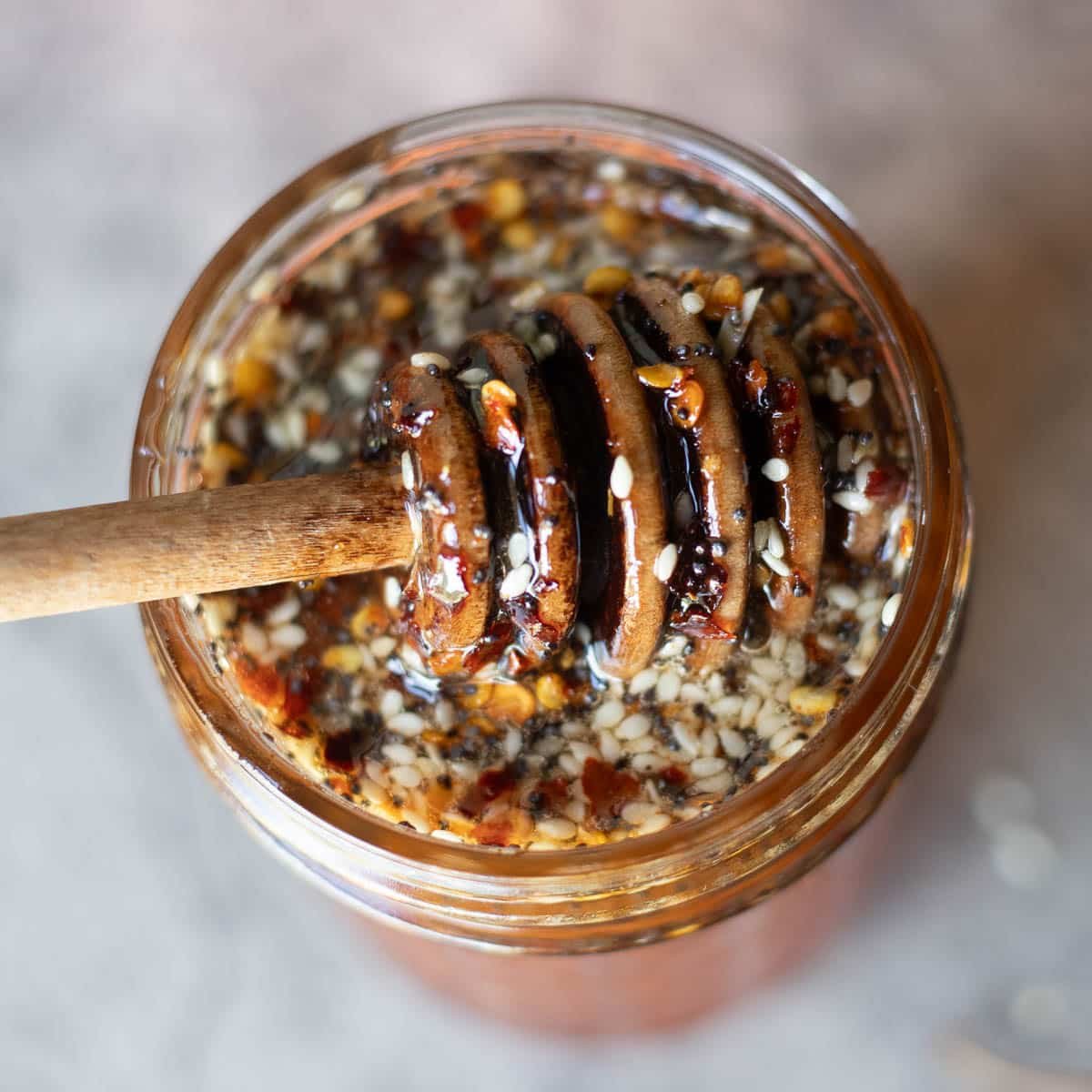 top view hot honey in a jar with stirrer