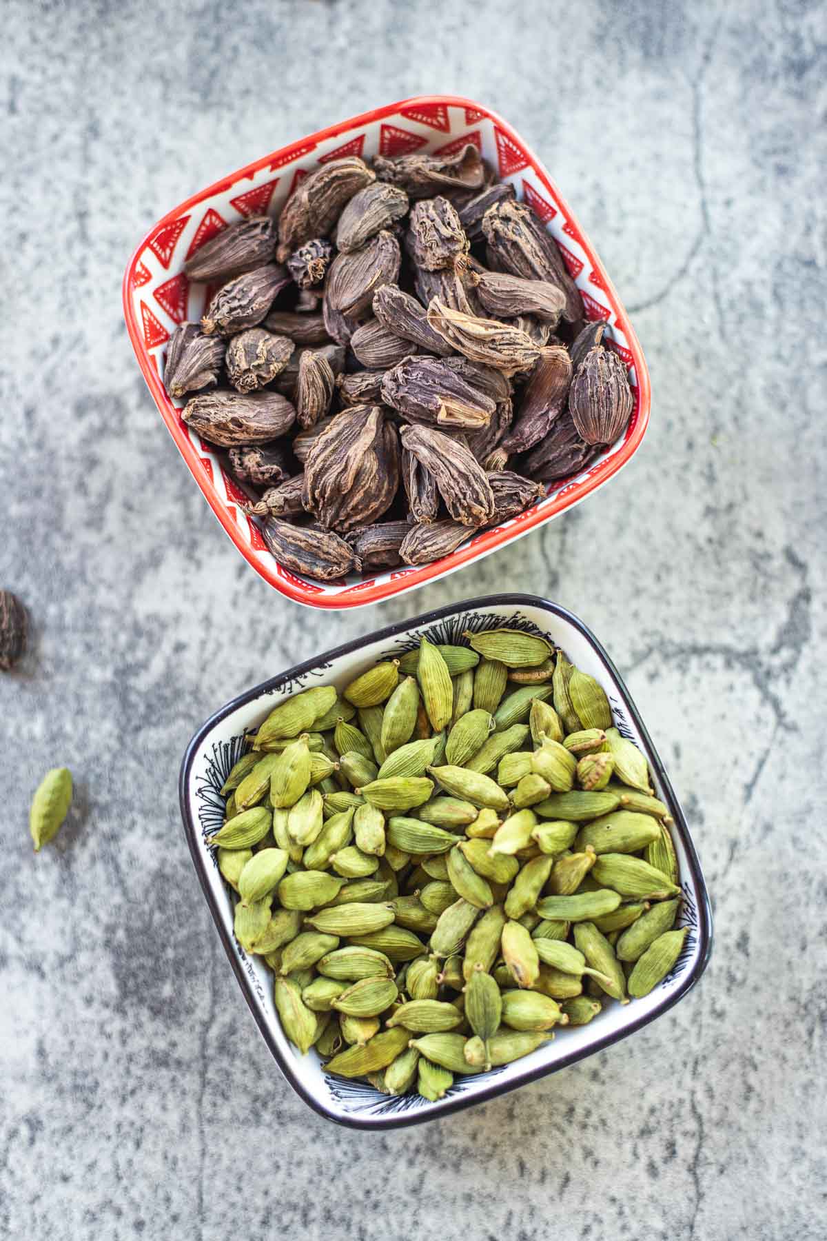 cardamom pods in two different bowls