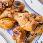 smoked chicken legs on a white and blue tray
