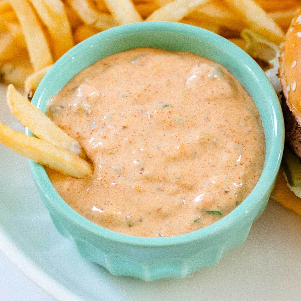 Big Mac sauce in bowl with fries and big mac