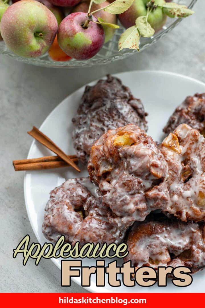 applesauce fritters on a plate with more apples next to the plate