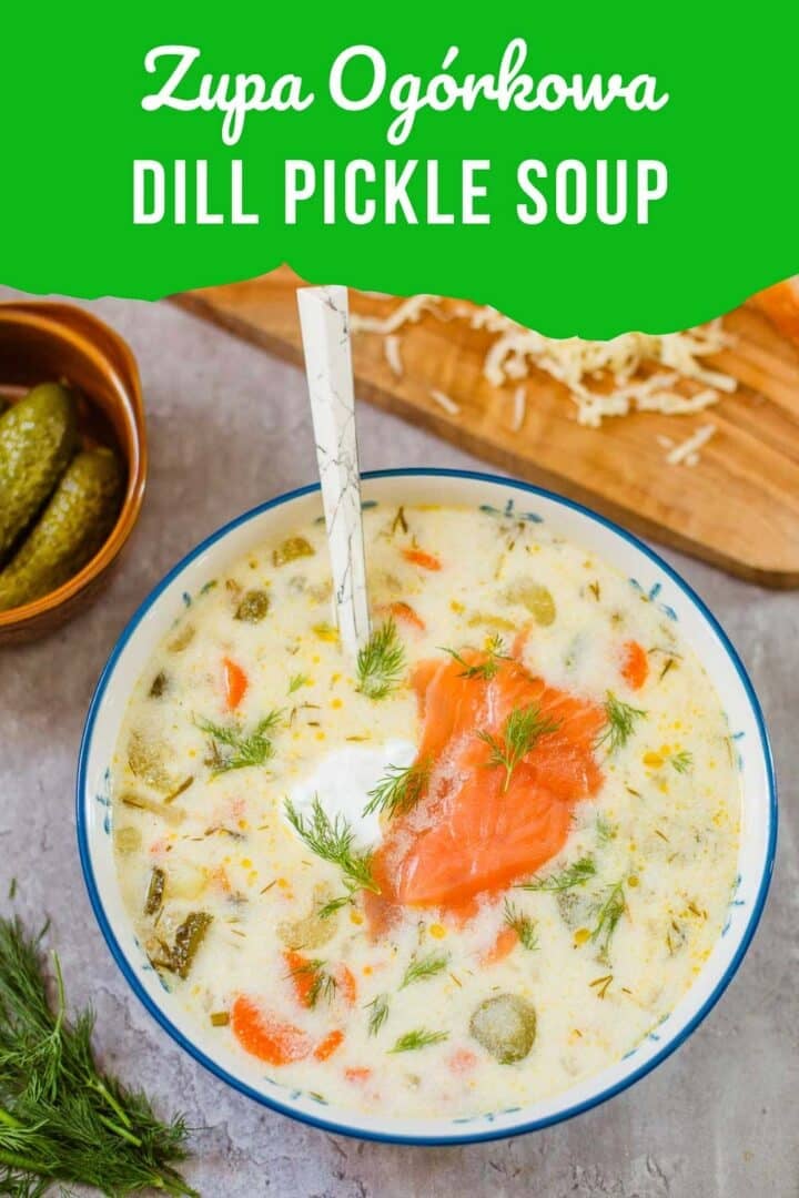 zupa ogorkowa (polish dill pickle soup) in bowl beside pickles, dill, shredded cheese