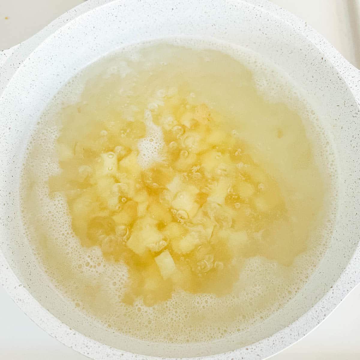 cubed potatoes boiling in water