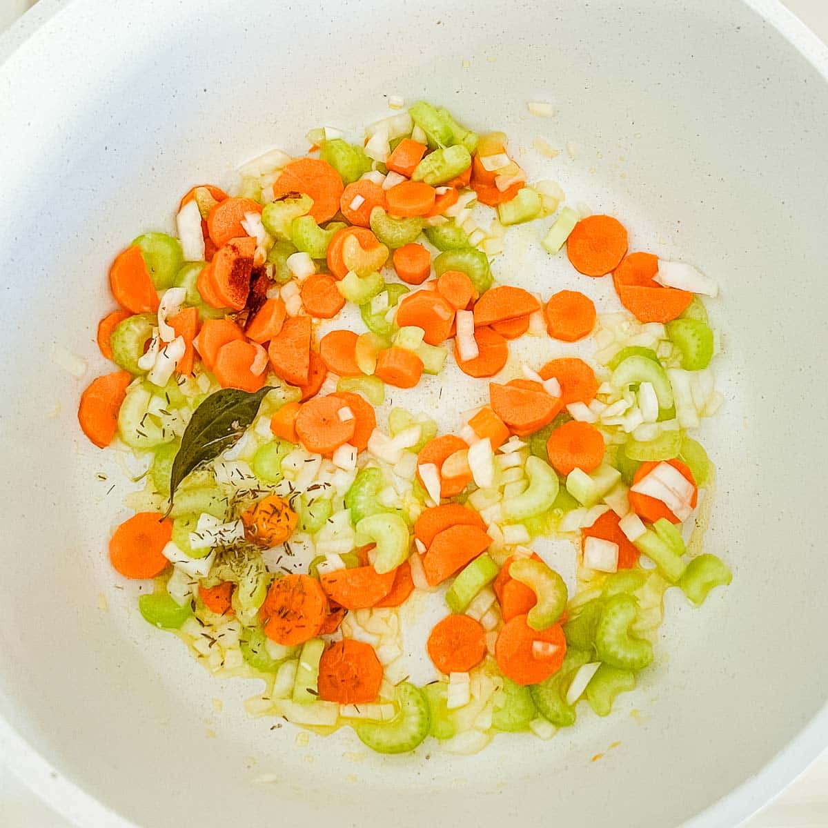 chopped veggies and spices in pot