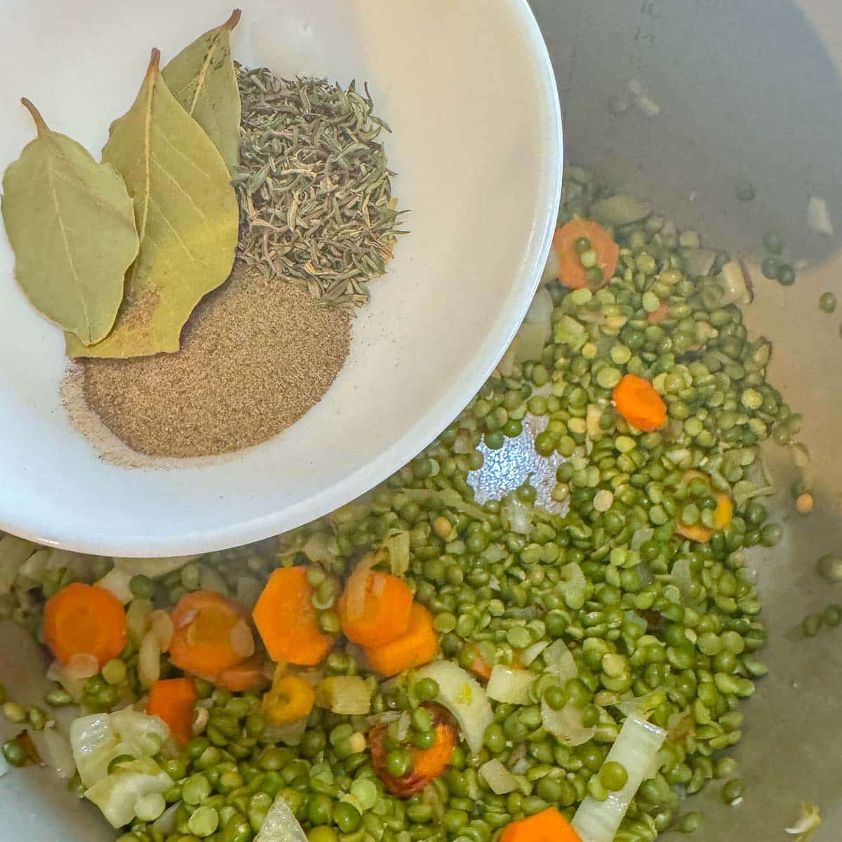 spices being added to soup ingredients