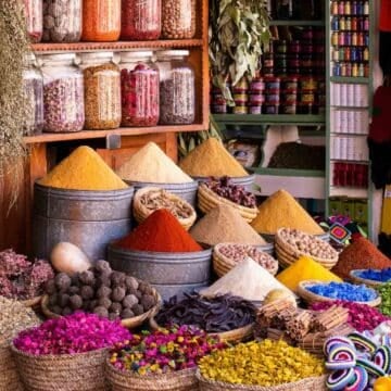 middle eastern spices in various containers at a market