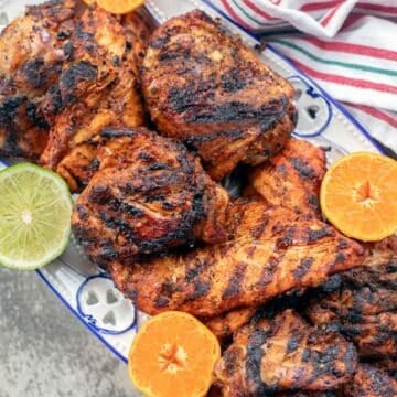 pollo asado with sliced limes and oranges.