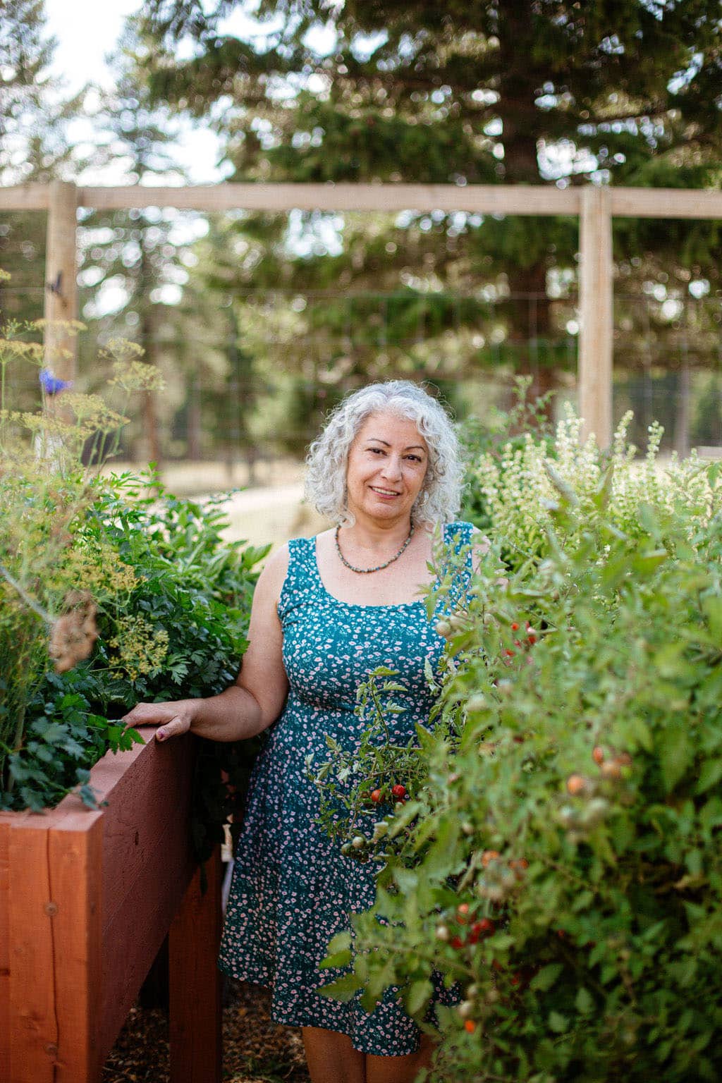 a lady in the garden with a blue dress on.