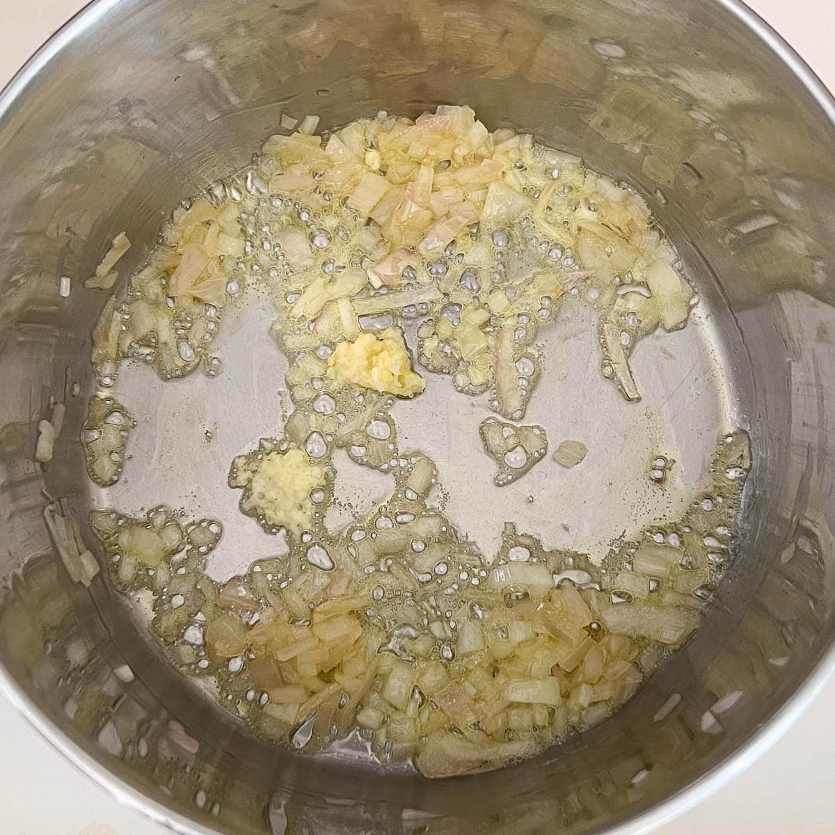 softened shallots with minced garlic added to saucepan.
