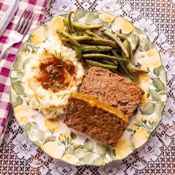 venison meatloaf with greenbeans, mashed potatoes, and gravy.