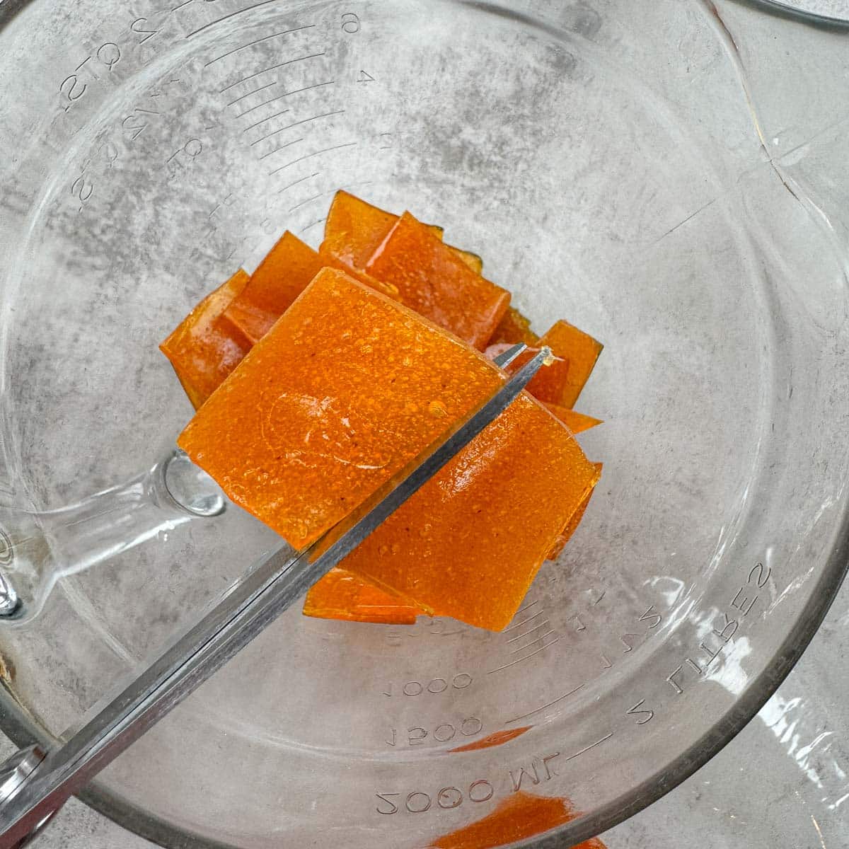 apricot paste being cut into squares.