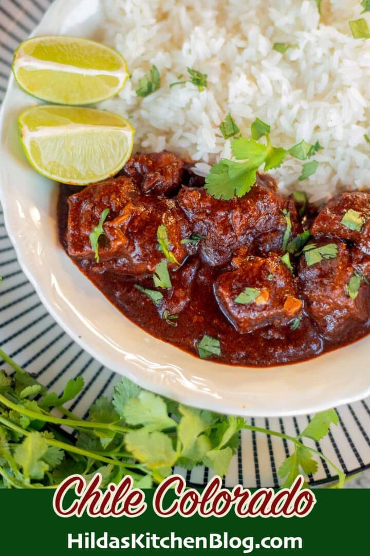 chile colorado with white rice, lime wedges, and cilantro.