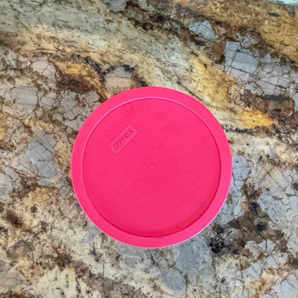 a bowl with a pink lid.