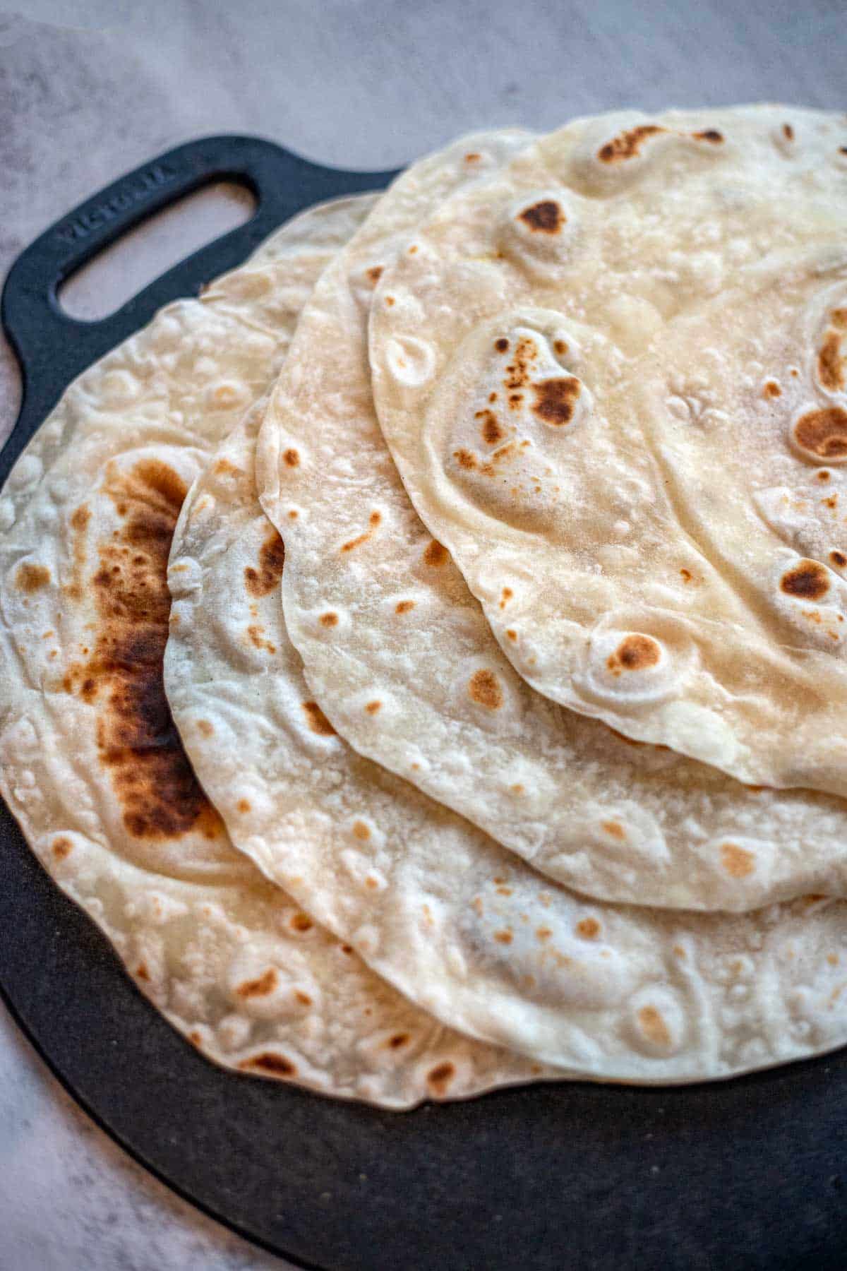 sourdough discard tortillas on a cst iron pan.