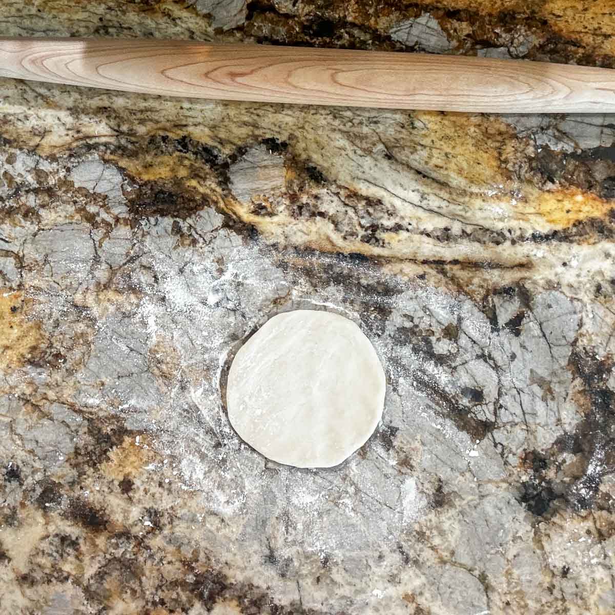 a small rolled out piece of sourdough discard tortilla dough.