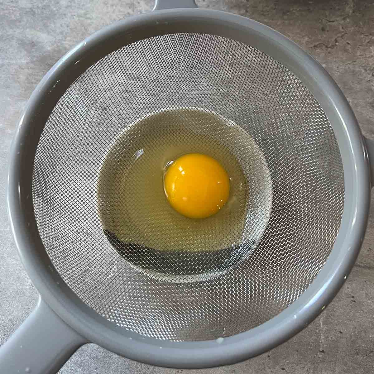 egg in fine mesh strainer.