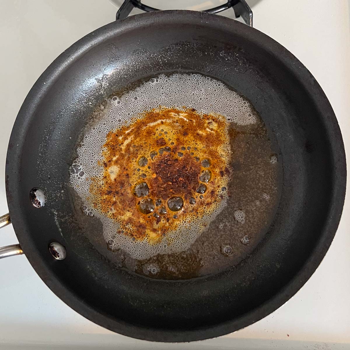 harissa added to butter in a pan.