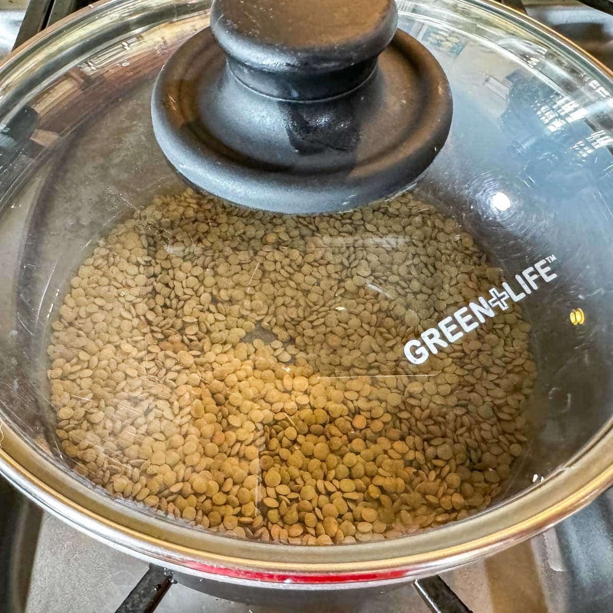 lentils in a pot being cooked.