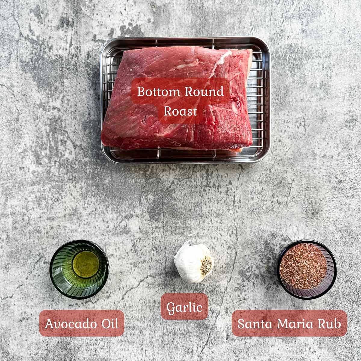 bottom round roast recipe ingredients including roast, oil, garlic, and rub.