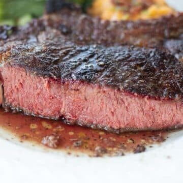 smoked ribeye steak sliced to show pink middle.