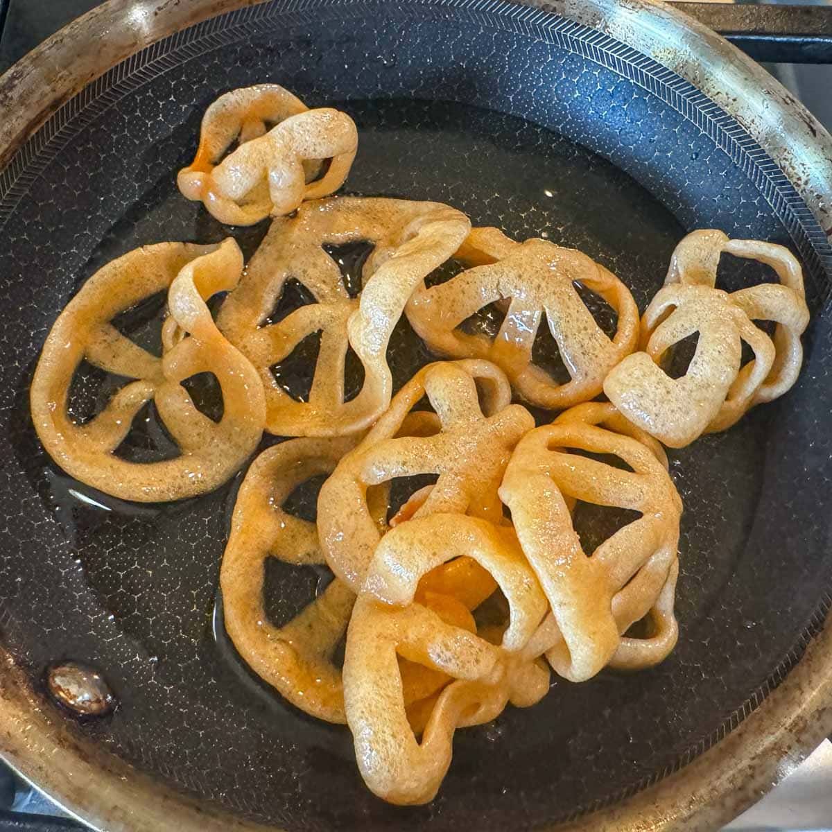 fried chicharrones in a pan of oil.