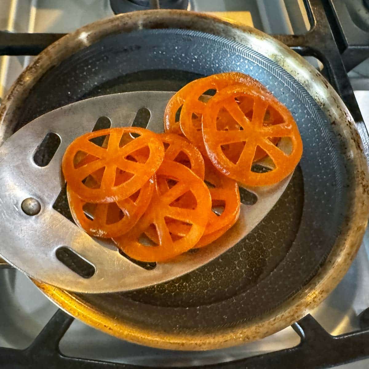 chicharrones being added to hot oil in pan.