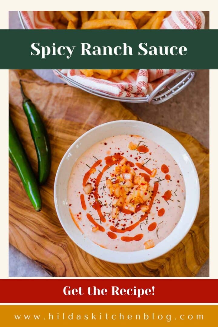 bowl of spicy ranch sauce with a swirl of hot sauce and diced kimchi on top and fries and serranos on the side.
