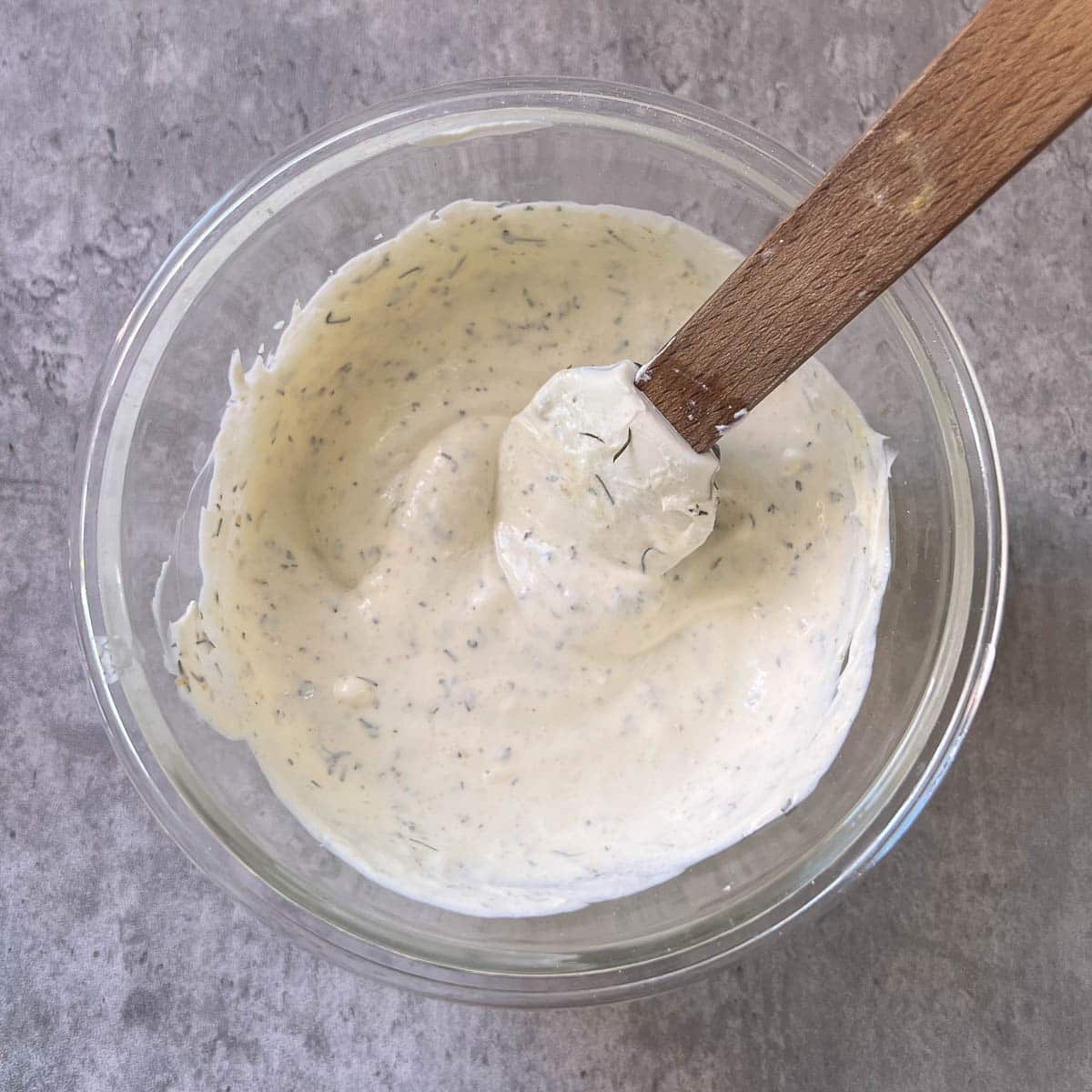 ranch sauce in a bowl after mixing with a rubber spatula.