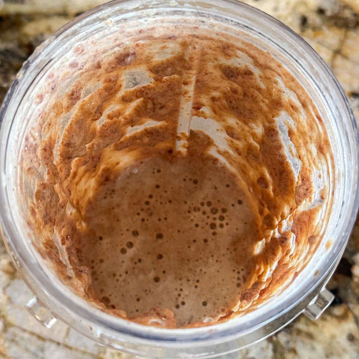 dates blended with milk in shaker cup.