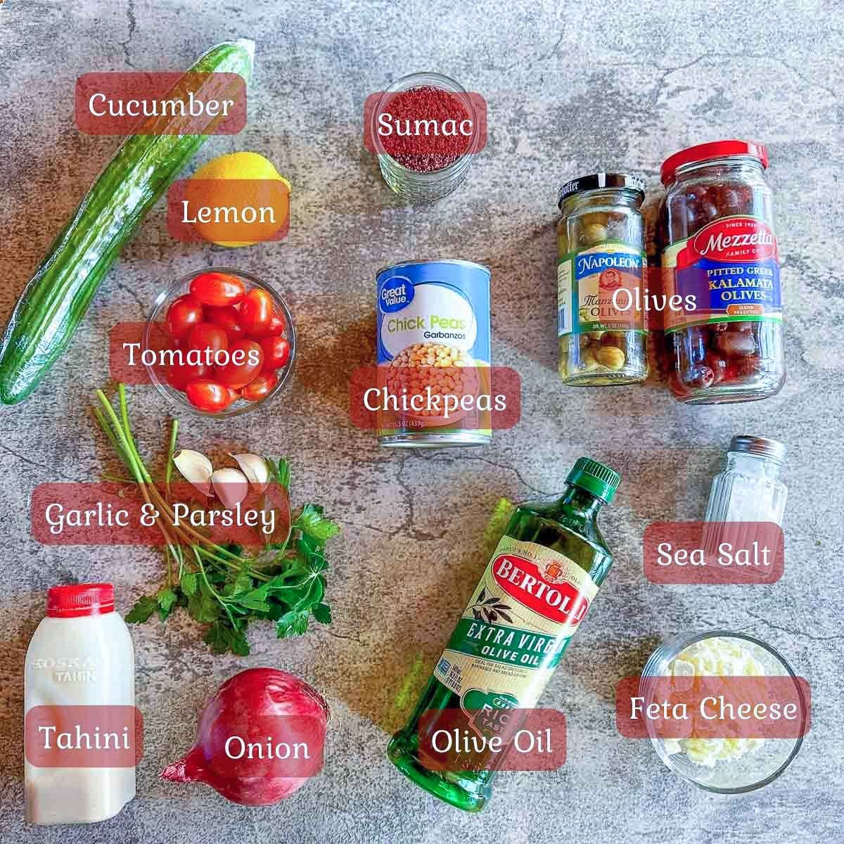 loaded nachos ingredients including chickpeas, veggies, olive oil, tahini, and feta cheese.