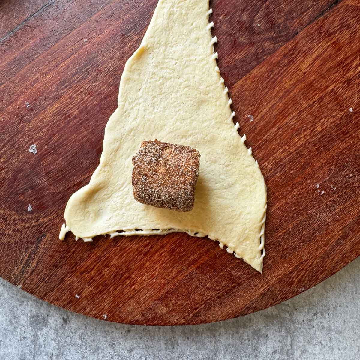cinnamon covered marshmallows on  crescent dough .